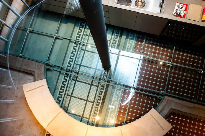 Shinshūya’s original tiled floor is visible beneath the glass panes of the new raised floor of Or House.​​