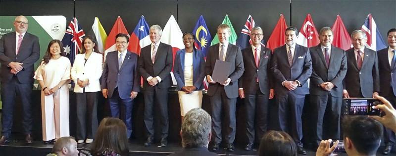 Ministers from the Trans-Pacific Partnership member nations pose for a photo after Britain officially joined the free trade pact at a signing ceremony in Auckland, New Zealand, on July 16, 2023. Photo: Kyodo via TPG