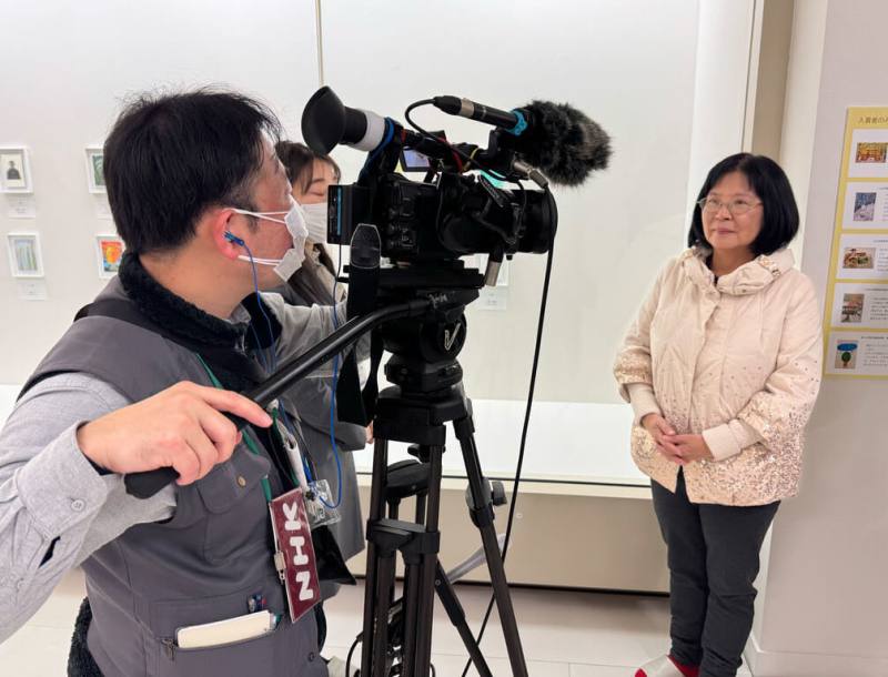 藝術家李麗琴（右）獲得日本車屋美術館主辦「10x15世界大賽」最高榮譽市長獎，她11日前往領獎，並接受NHK和讀賣新聞採訪。李麗琴表示，她在創作中想傳達愛的訊息，藉由比賽看見更遼闊的風景。（李麗琴提供）