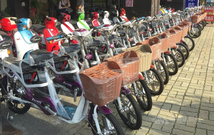 A row of electric bicycles (front) displayed at a local rental shop.