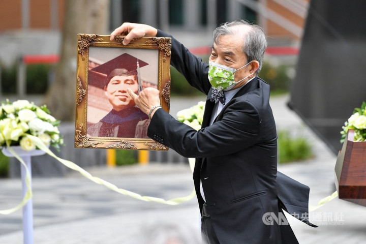 A family member holds a portrait of Chen Wen-chen during a commemoration event held earlier this year. 