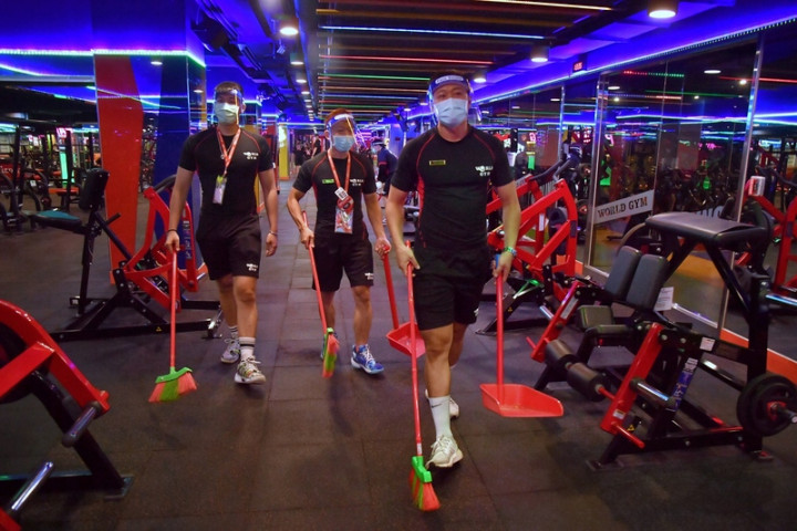 中央流行疫情指揮中心宣布全國第3級防疫警戒延至26 日，但部分措施會適當「微解封」，其中包含室內外運 動場館。台北市一家健身中心12日全面清潔環境。