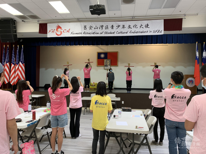 Teacher Ma leads returning dancers on demonstrating the ceremonial dance moves