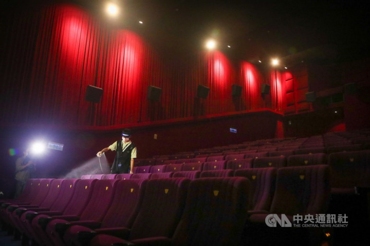 An employee at a movie theater in Taipei disinfects seats between showings.
