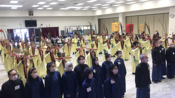 Dancers performing the six-row dance to a portrait of Confucious
