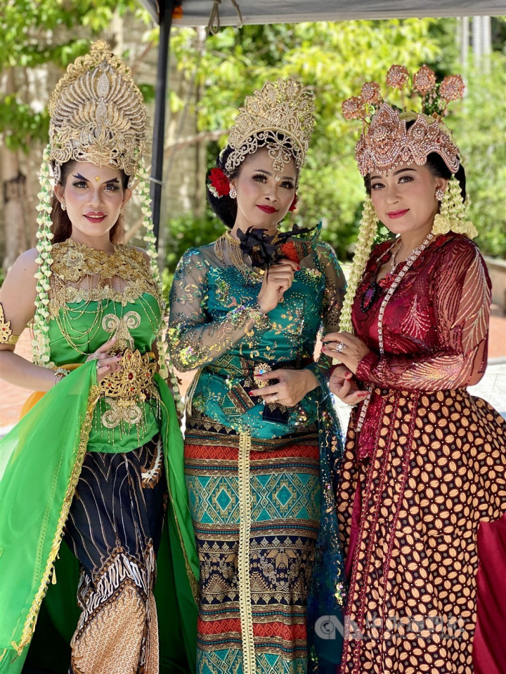 Indonesian traditional costume and gown designer Yayuk Sri Rahayu (center) poses with models wearing her creations. An Indonesian caretaker of 13 years, she plans to manage her own costume rental business in Indonesia next year. CNA photo Oct. 3, 2021