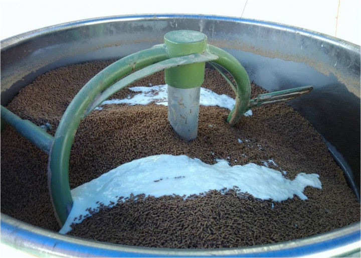 Yogurt is mixed with feed in a dispenser. Photo courtesy of the Fisheries Research Institute