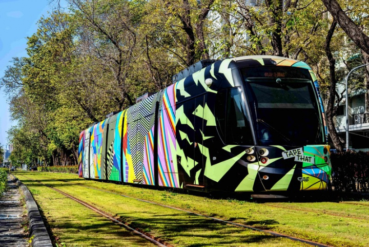 設計團隊以螢光膠膜搭配蓄光膠帶在「微光流動」列車上勾勒雨後彩虹、海灣波光粼粼、建築錯落有致、交通道路錯綜複雜的高雄城市意象。（高雄市政府提供）