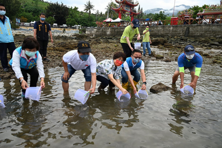 台東縣長饒慶鈴（前右3）等人14日和民眾一起前往杉原灣放流魚苗。她表示，自109年起在杉原灣海域移植硨磲貝，復育存活率達9成，成為本島第一個硨磲貝復育成功地區，這次縣府再攜手台東區漁會、台東大學等單位，放流2萬4000尾嘉鱲魚苗。（台東縣政府提供）