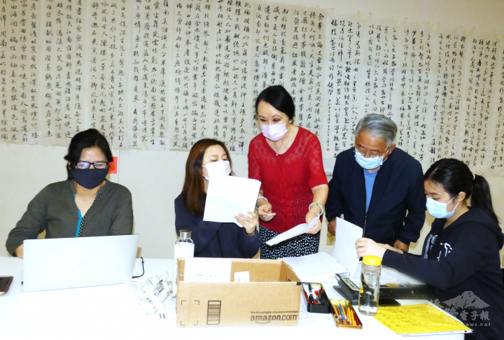 譚嘉陵 (中)   和協助登錄評審成績的學生、志工們核對資料