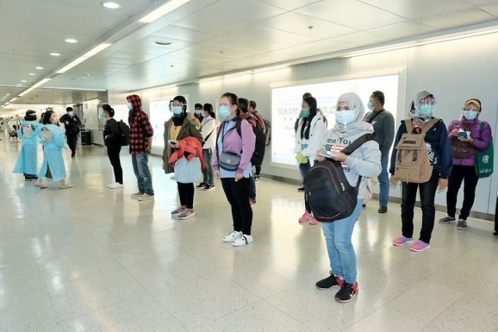 Officials greet workers from Indonesia in Indonesia at Taiwan Taoyuan International Airport, after Taiwan relaxes border restrictions for laborers from the Southeast Asian country.