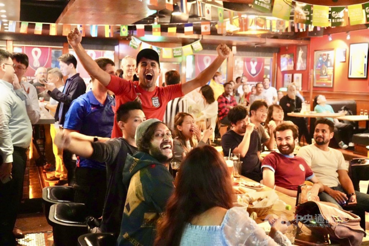 Sports fans celebrate after a goal. 
