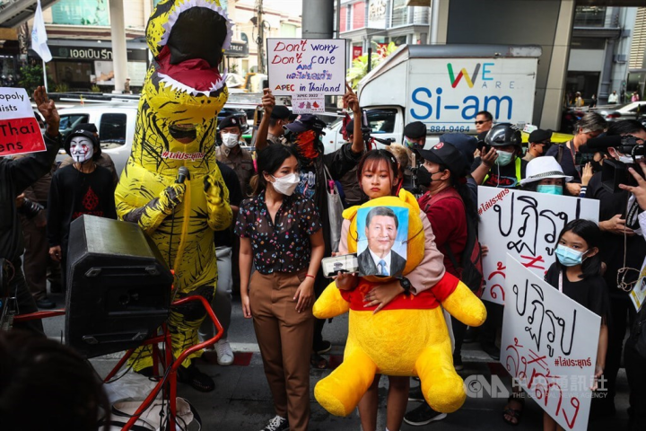 Activists gather near a venue of the APEC events in Bangkok to protest for various causes, including one carrying a Winnie-the-Pooh bear and a picture of Chinese President Xi Jinping, on Thursday. 