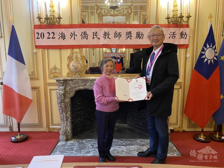 駐法國代表處大使吳志中（右）代表僑委會委員長童振源頒發教師獎勵獎狀及銀質獎章予20年屆教歷李珠鑾老師（左）