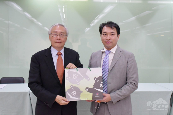 張良民(左)致贈禮品，由中小企業總會副理事長林倬立(右)代表接受