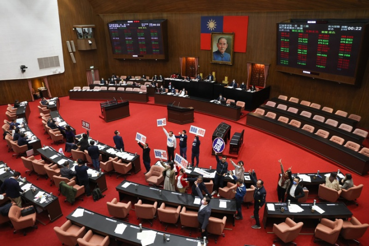 立法院會21日討論攸關全民發現金新台幣6000元的疫後強化經濟與社會韌性及全民共享經濟成果特別條例草案，民進黨團和國民黨團都甲級動員備戰，無共識條文表決處理。圖為民進黨團與國民黨團舉牌表達立場。