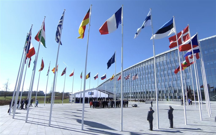 National flags of NATO member states, including its new member, Finland are raised in front of the organization's headquarters in Brussels on April 4, 2023.