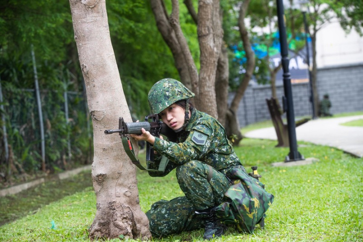 首梯女性受召人員8日在桃園八德戰術位置入營，9日進行5公里戰術行軍課目，並在市區公園戰鬥教練，圖為女性官兵實施警戒。