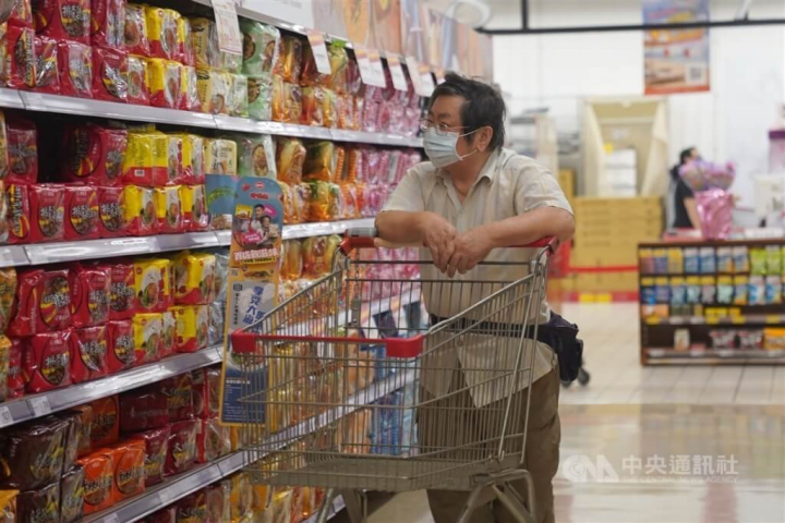 A shopper passes a shelf stacked with instant noodles at a Taipei supermarket in this undated photo. 