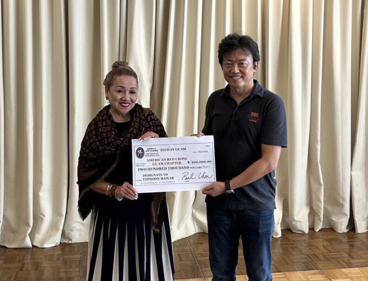 A check presentation for a donation of US$200,000 is presented by TECO Guam Office Director-General Paul Chen (right) to Chita Blaise, head of the American Red Cross Guam Chapter, on Friday to help the western Pacific island with recovery efforts in the aftermath of Typhoon Mawar. Photo courtesy of the Taipei Economic and Cultural Office in Guam