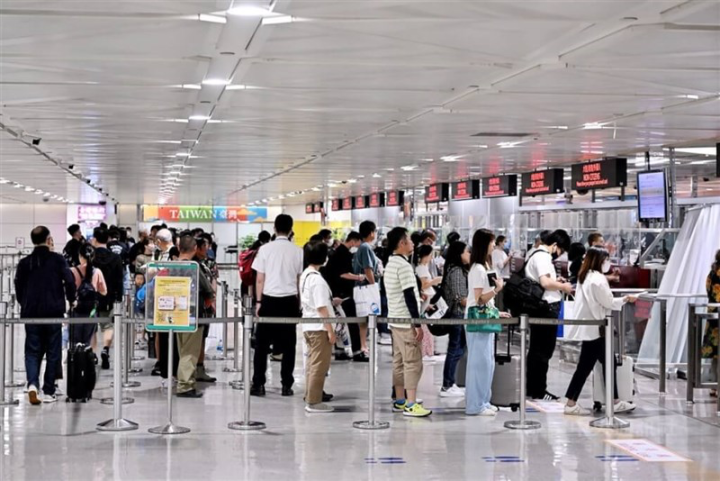 Passengers wait in line at Taoyuan International Airport in this undated photo. 