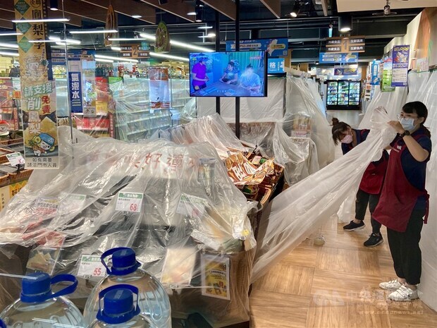 Workers at the supermarket prepare the store for disinfection on Friday.