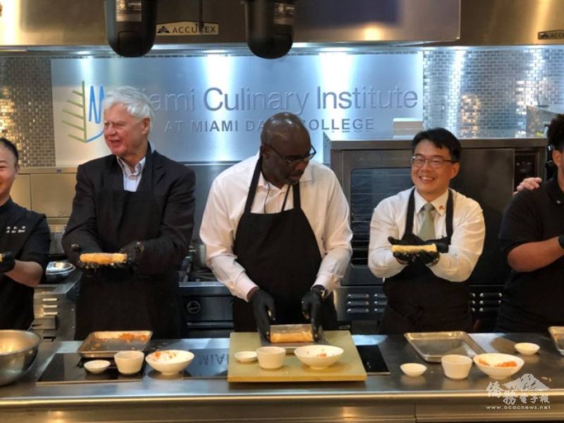 Director Chou (right) joins hands with Consul General of Saint Lucia, Darrel Montrope (center), and Advisor to the Consular Corps of Miami, Ambassador Volker Anding (left), as they prepared the chicken rolls (Photo Credit: TECO in Miami).