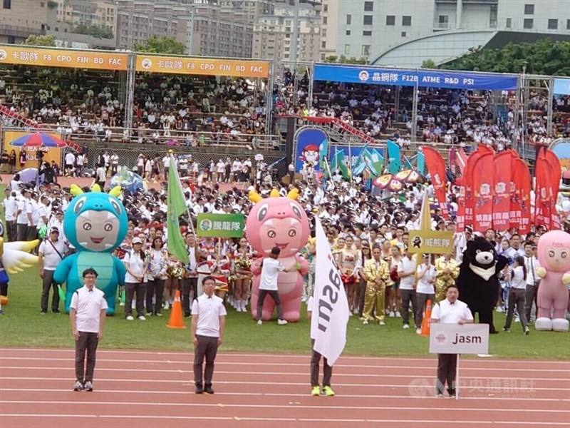 Japanese employees of Taiwan Semiconductor Manufacturing Co. pose in front of other colleagues in the Hsinchu County Stadium Saturday.