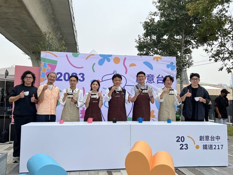 台中市文化局27日在綠空鐵道南段舉行「2023創意台中X鐵道217」活動開幕式，文化局副局長曾能汀（左5）、民進黨台中市議員黃守達（左6）等人手沖咖啡，營造幸福儀式感氛圍。