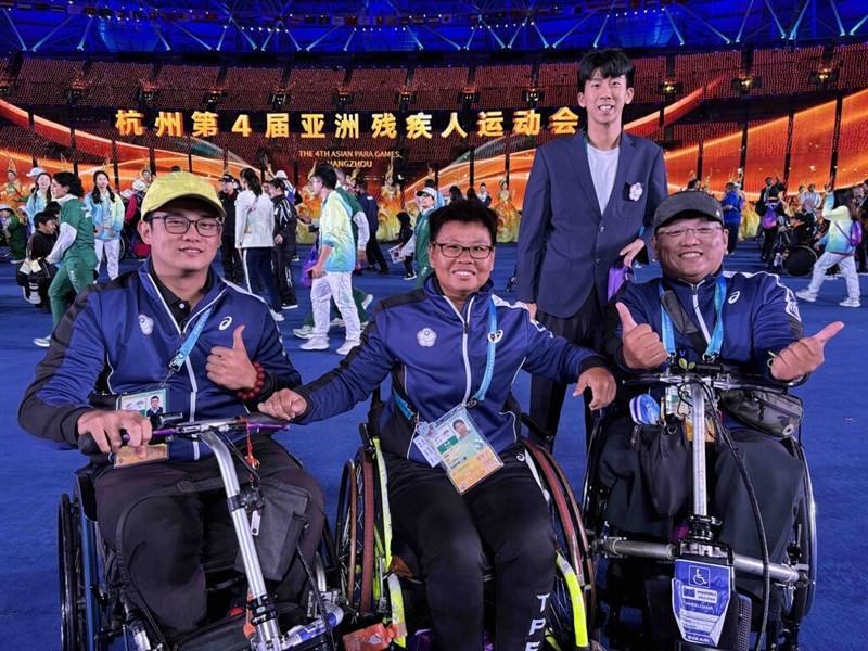 Four members of Taiwan's delegation to the 2023 Asian Para Games pose together on Saturday during the closing ceremony of the sports event in Hangzhou. Photo courtesy of Sports Administration