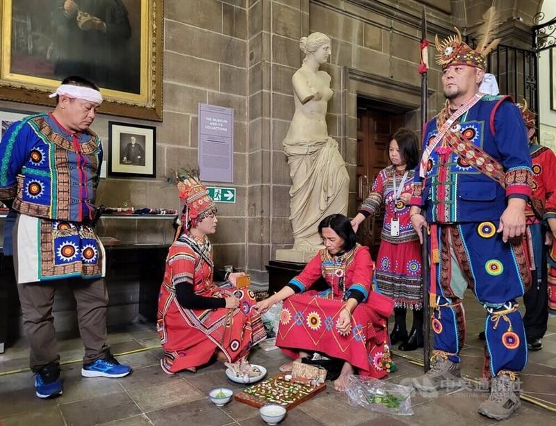 Civur Malili (seated center), a "pulingaw" (shaman) of the Taiwan's Paiwan people, leads the Paiwan delegation to Edinburgh in a ritual ceremony to relocate the skulls of the four fallen warriors.