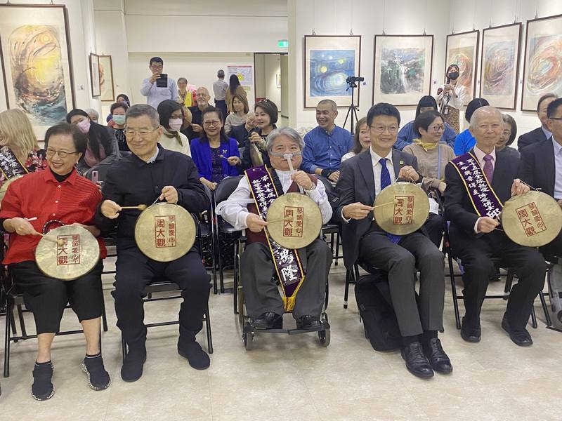 旅美畫家邱伯安（前右）與周大觀文教基金會等單位13日合辦「用畫說道傳愛大展」記者會，前副總統蕭萬長（前左2）特別出席，一同敲鑼替畫展拉開序幕。