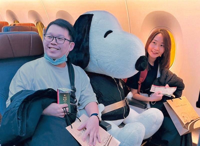 A Snoopy doll sits between two passengers on Starlux Airlines' inaugural flights from Taipei (Taiwan Taoyuan International Airport) to San Francisco on Saturday. Photo courtesy of Starlux Airlines Dec. 17, 2023