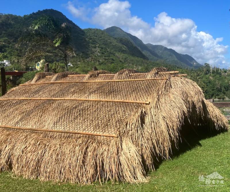 A hand-made long-grass roof created by binding dried grass with bamboo strips. The base of the roof is made with wooden planks and logs.