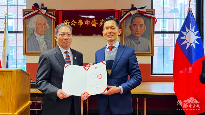 廖朝宏(右)頒發賀狀給紐英崙中華公所主席雷國輝