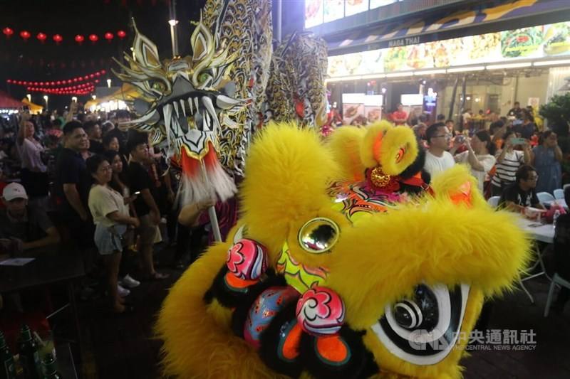 Dragons dance along the street to send blessings to onlookers. CNA photo Feb. 18, 2024