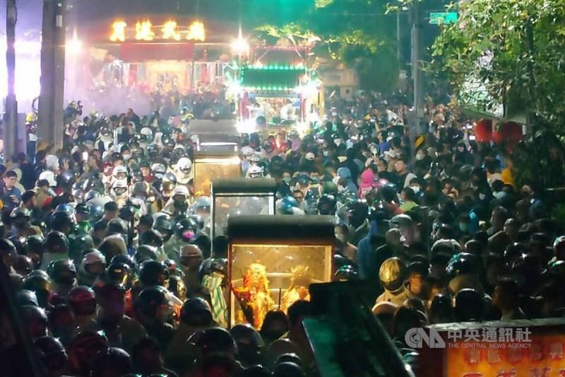Statues of deities are safeguarded inside ceremonial palanquins while event attendees don protective gear to get ready for the Yanshui Beehive Fireworks Rockets Festival on Saturday. CNA photo