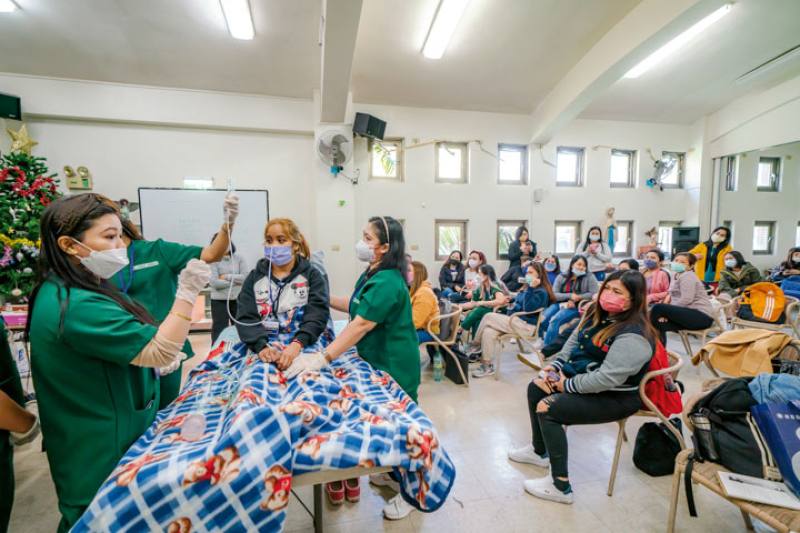 Filipina caregivers use a public space inside St. Christopher Church for a training class.