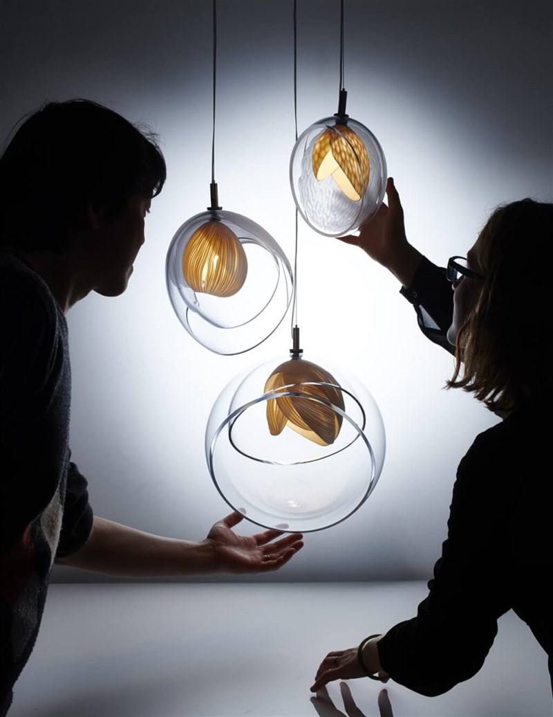 Stan Chen (left) and his Italian associate Cristina Vezzini (right) inspect their artwork. Photo courtesy of Chen and Vezzini