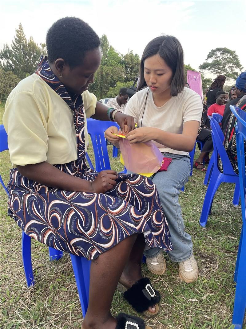 A local resident sews a reusable pad with a Love Binti staff. Photo courtesy of Love Binti June 1, 2024