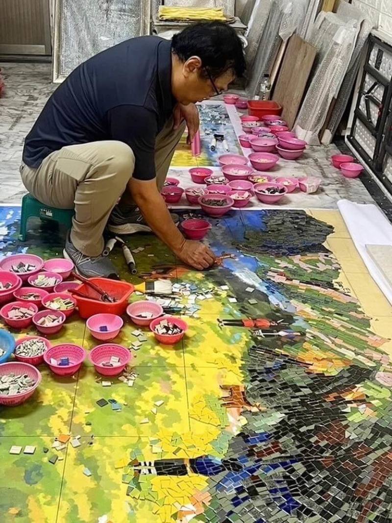 嘉義縣阿里山鄉達邦國小鄒族神話藝術牆近日完工，藝術家歐志成（圖）依據鄒族口述歷史大洪水避難逃到玉山的故事及神話，以馬賽克創作拼貼完成。（歐志成提供）