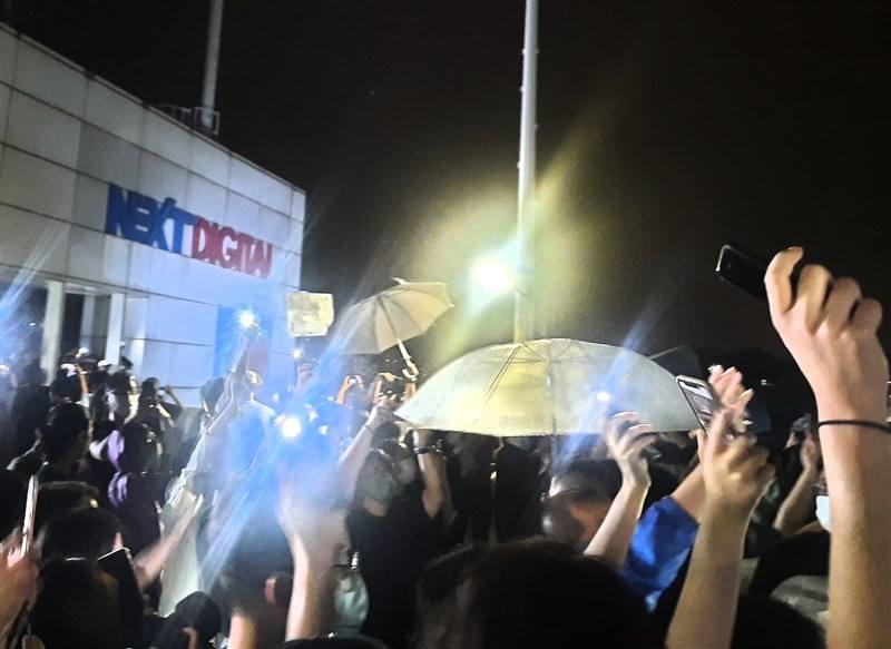 Apple Daily employees gather on the rooftop of the newspaper headquarters in Hong Kong on June 23, 2021, waving to supporters gathered outside in this photo provided by Shirley Leung.