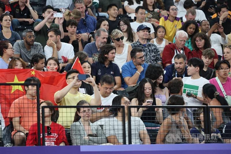 The fan (front, in white t-shirt) wearing a t-shirt with 'Taiwan' printed on is asked by a staff member (left of the fan, with mustache) to put on a jacket. CNA photo Aug. 5, 2024