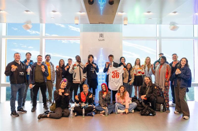 林副署長拿著英國網紅們簽名球衣在101景台合照