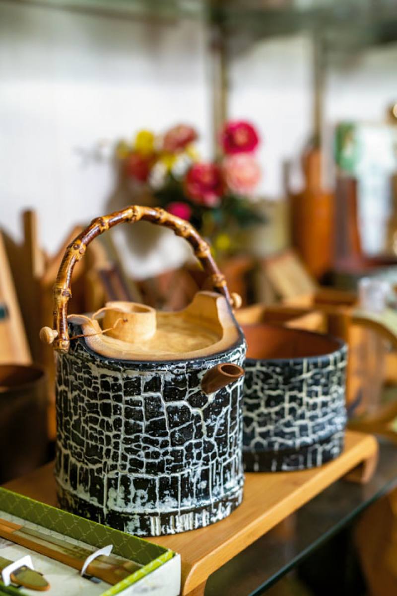 Clay and sulfuric acid were applied to the bodies of these bamboo teapots to etch the cracks and mottled patterns into the surface of the bamboo.​​