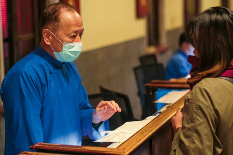 As the deacons at the temple counter help believers to interpret the classical Chinese language of divination texts, they are also providing solace to their troubled and anxious minds.​​