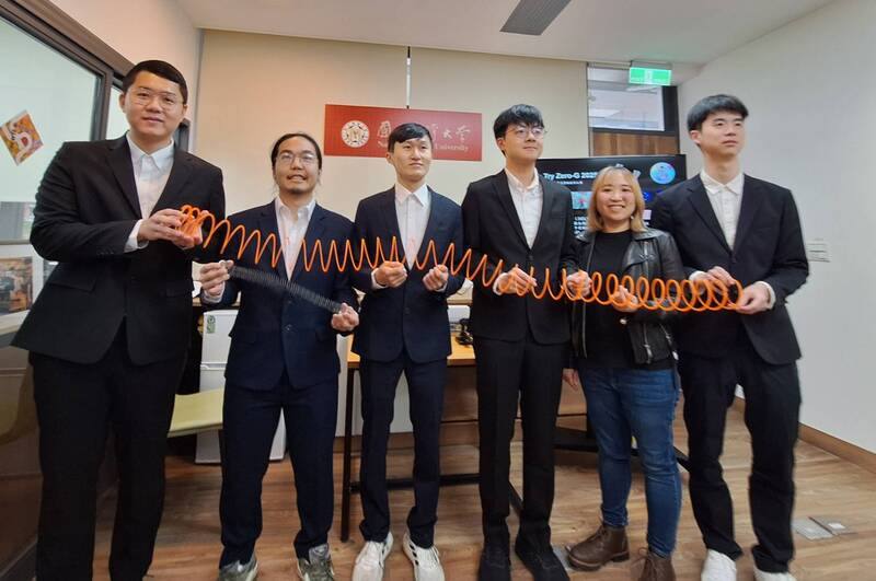 A National Taiwan University team of students pose with slinkies, which inspired their project. CNA photo April 2, 2025