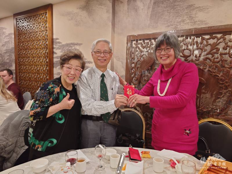 鄧倩麗〈右者〉代表蒙特婁分會收下廖慶祥〈中者〉致贈的祝福紅包。左為鄭秀明