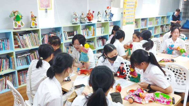 台北市立中山女高合唱團16日到雲林縣重興國小進行城鄉文化交流活動，學習布袋戲操偶技巧等，讓北部學子加深對雲林特色和傳統文化理解，也展現城鄉學生互動合作美好畫面。（重興國小提供）