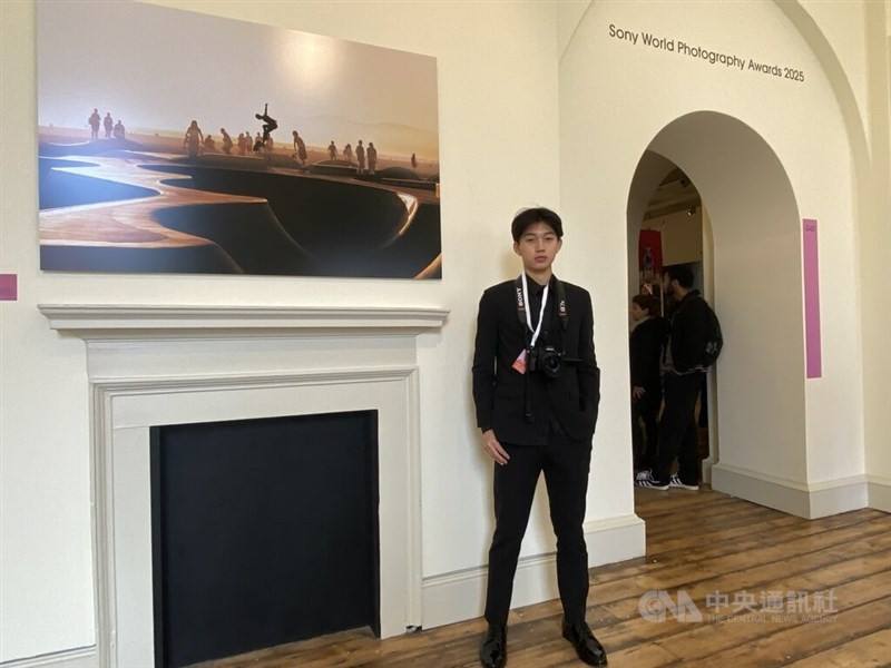 Daniel Dian-ji Wu pose in front of the photo which won him the Youth Photographer of the Year recognition at the 2025 Sony World Photography Awards in London. CNA photo April 16, 2025